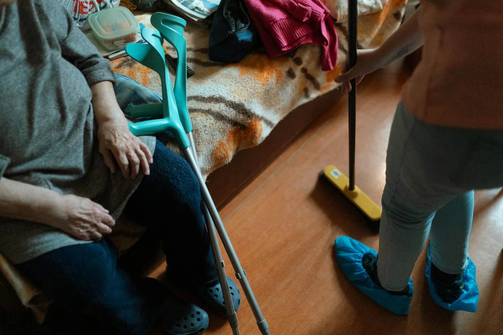 A caregiver assisting an elderly woman in a home care setting.