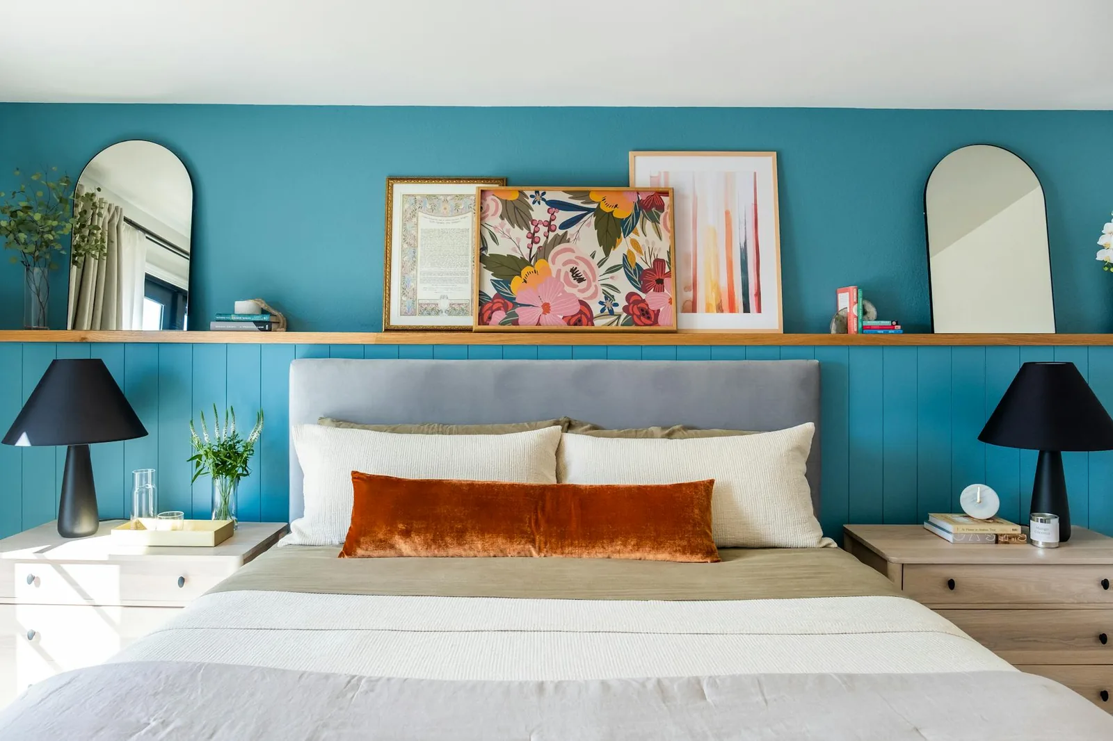 A bright bedroom with calm colors, soft lighting, and familiar decor above the bed.