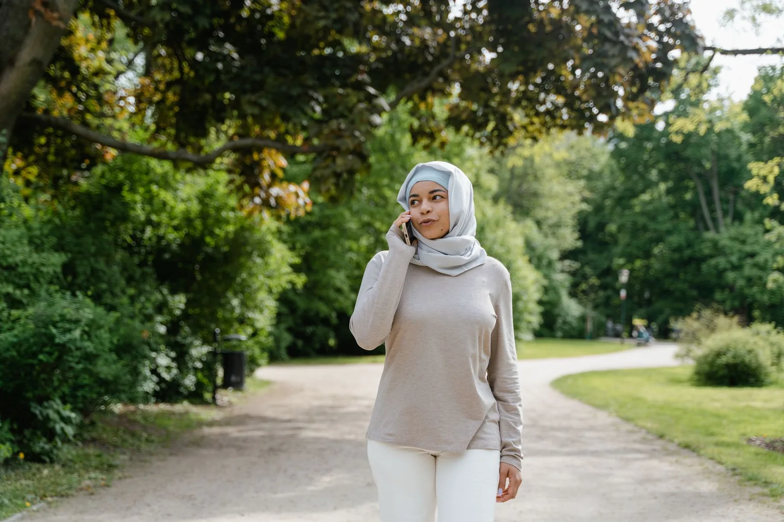Woman talking on a phone while walking outdoors